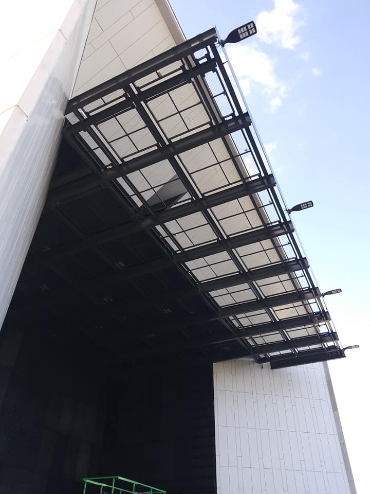 Part of the 52 panel SkyDeck tension wire grid at White River State Park in Indianapolis extends downstage over a small apron. The portion of the grid is surrounded by a lifeline system by Tractel to prevent anyone working in that area from falling off the grid.